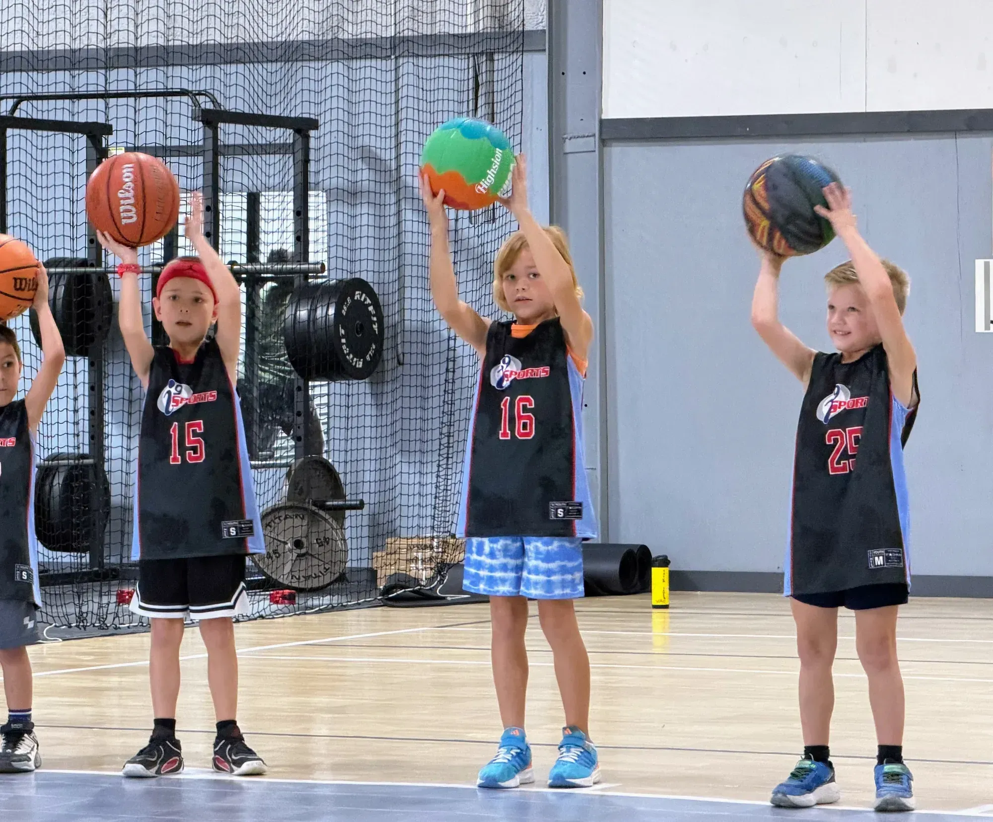 Kids on the court during a beginner basketball game