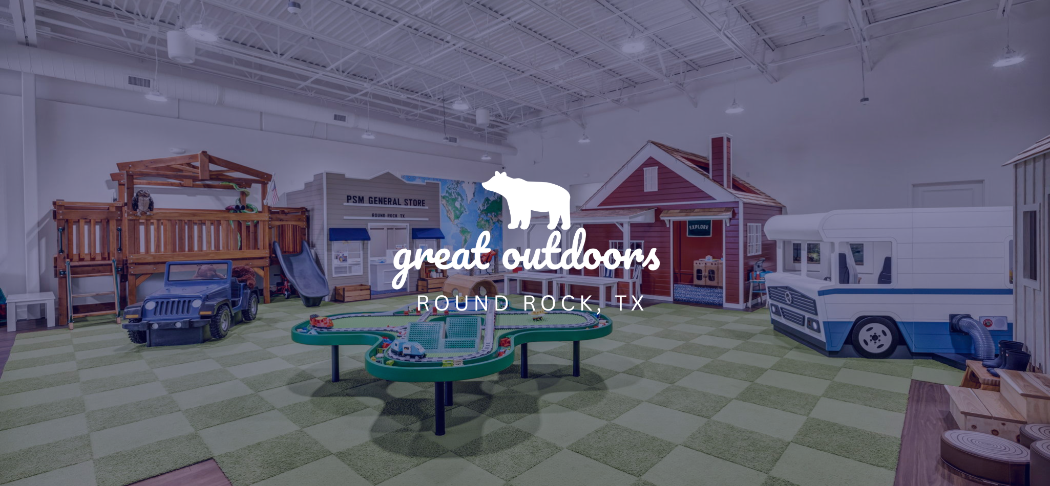 Play Street Museum’s Great Outdoors exhibit with a general store, cabin, camper and play vehicles.